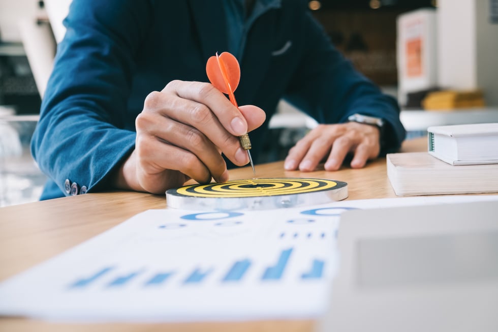 Businessman Holding a Darts Aiming at the Target 